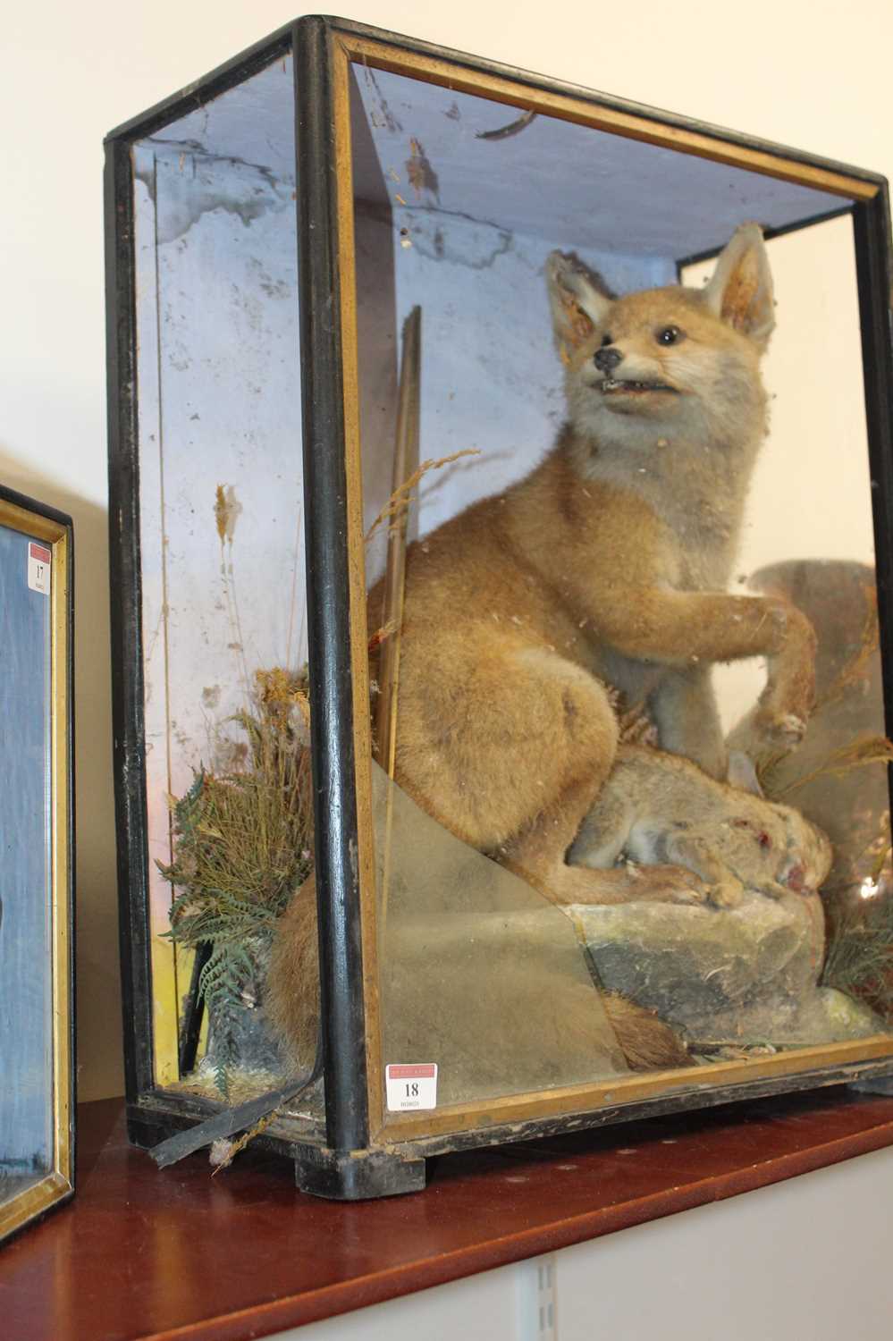 A Victorian taxidermy model of a fox with prey, in a naturalistic setting against a painted - Image 7 of 7