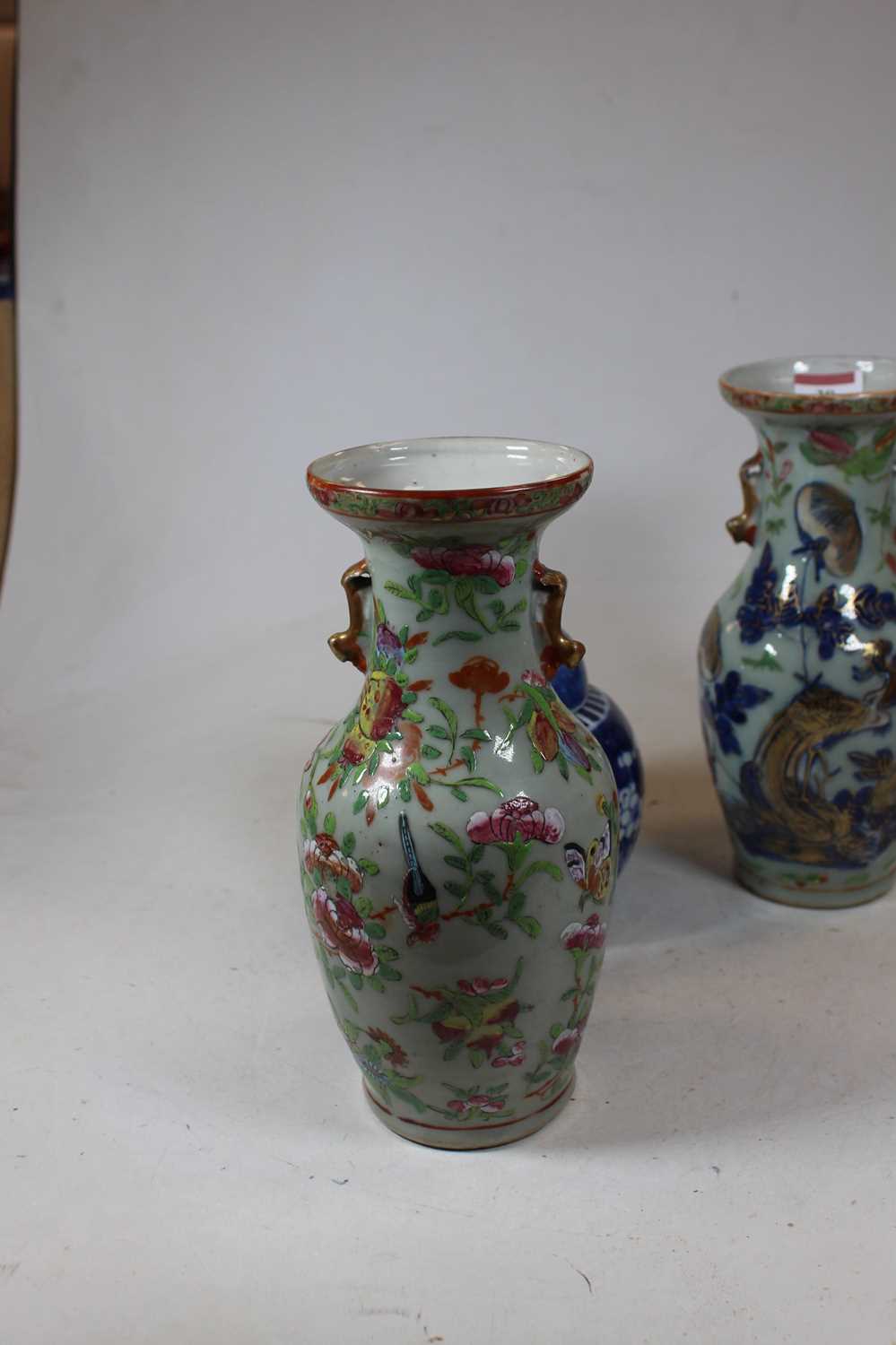 A pair of stoneware vases, each of baluster form, enamel decorated with various birds, butterflies - Image 4 of 13