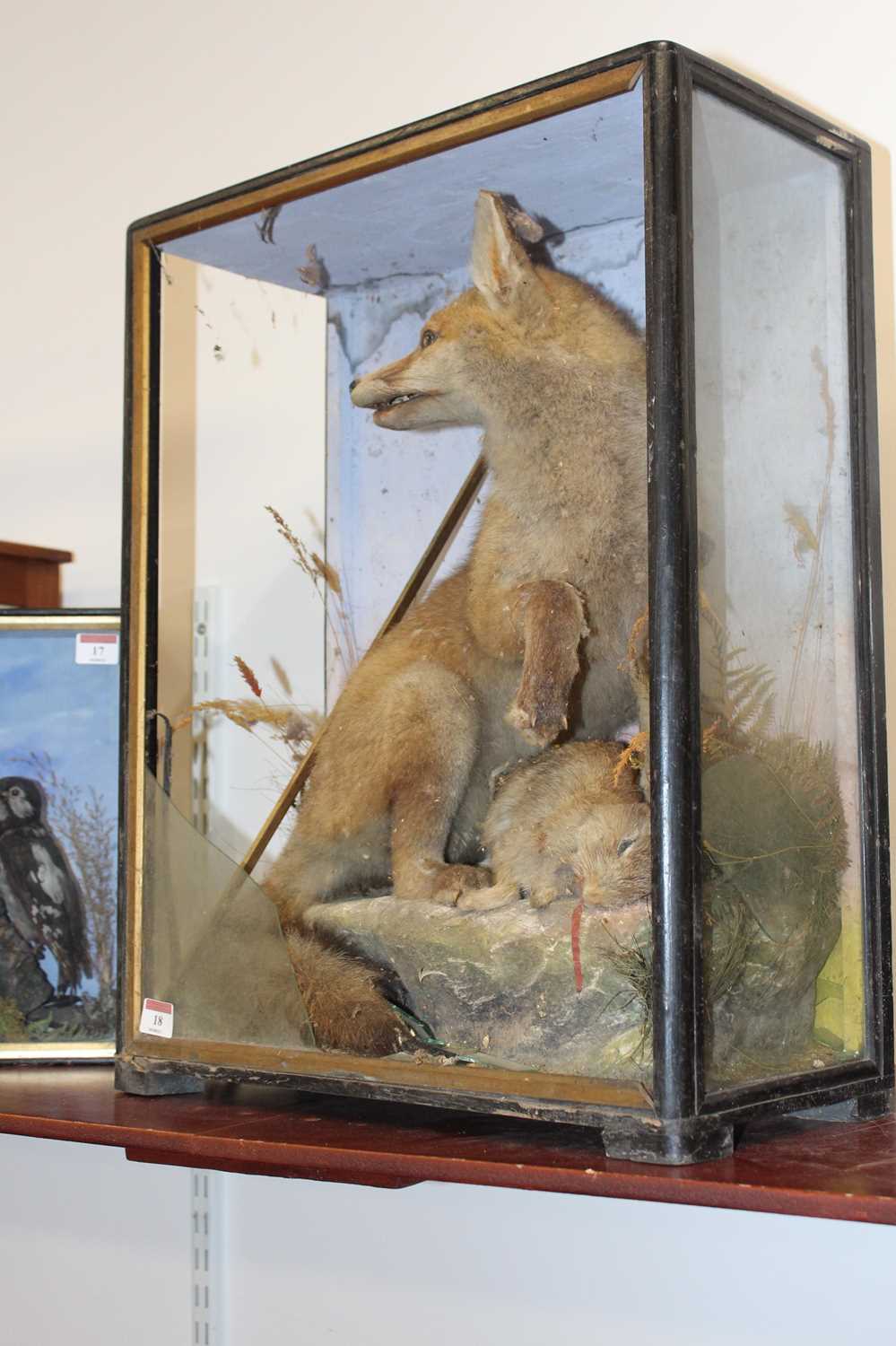 A Victorian taxidermy model of a fox with prey, in a naturalistic setting against a painted - Image 6 of 7