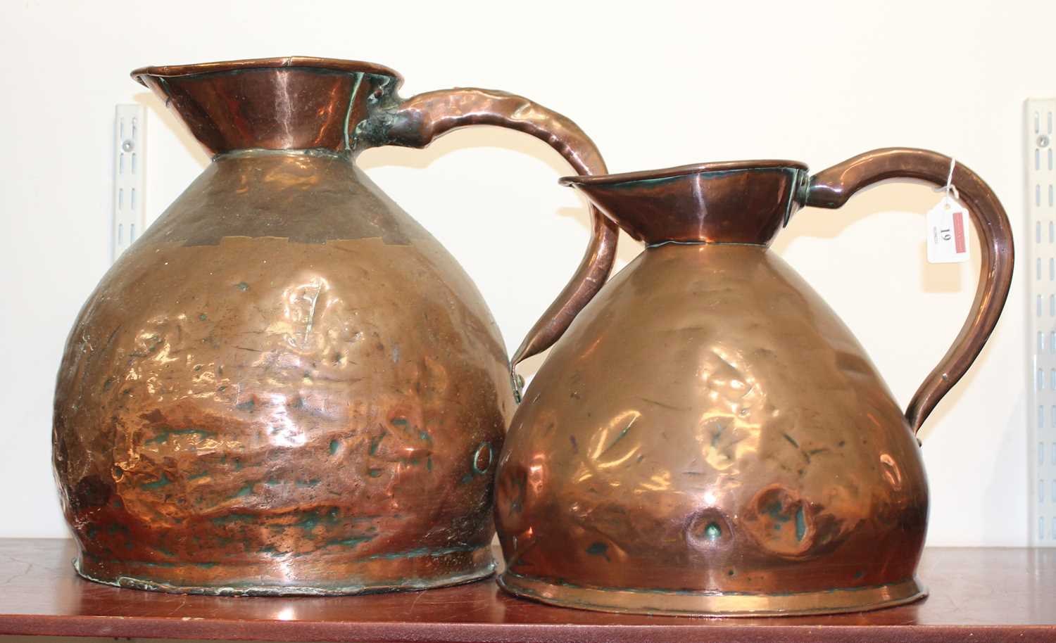 A large 19th century copper flagon, h.37cm; together with one other smaller example (2)