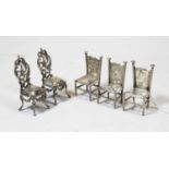 A matched set of three 19th century miniature silver chairs, each having a high back embossed with