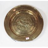 A 19th century copper charger, the centre relief decorated with a figure on horseback, within an