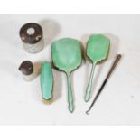 A George V silver and green guilloche enamelled part dressing table set to include hand mirror and