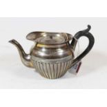 A late Victorian silver bachelor's teapot of half reeded form with ebonised handle, maker Stokes &