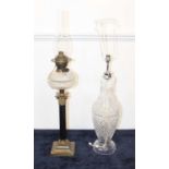 An early 20th century oil lamp, having clear cut glass font, on a Corinthian column and stepped