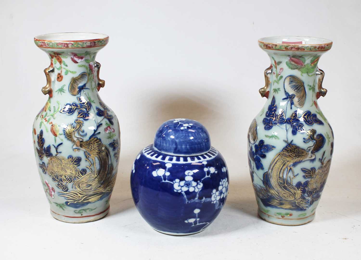 A pair of stoneware vases, each of baluster form, enamel decorated with various birds, butterflies