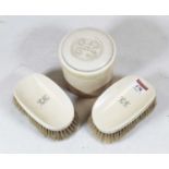 A pair of Victorian ivory backed hand brushes, each monogrammed LH; together with a cylindrical