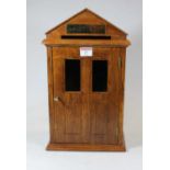 A 20th century oak letter-box in the form of a sentry box, having brass plaque enclosed by a