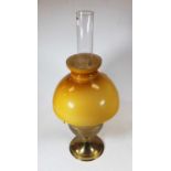 An early 20th century brass pedestal oil lamp, having opalescent glass shade