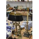 A 20th century table lamp in the Egyptian style, the twin sconces in the form of swans, having a