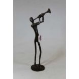 A contemproary bronzed model of a trumpet player, in standing pose, h.35cm