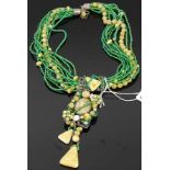 A beaded multi-strand green and yellow glass necklace, with white metal pendant