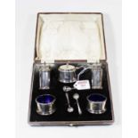 A George V silver five piece cruet to include mustard with blue glass liner, pair of pedestal salt