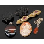 A carved shell cameo brooch; together with an agate set pendant; a Victorian carved jet brooch;