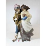 A large Lladro figure group of a boy and girl, him with his arm around her shoulder and her with a