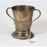 A small late Victorian silver loving cup of tapering form having a part fluted body, maker Henry