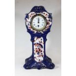 An early 20th century S Fielding & Co porcelain cased mantel clock, decorated in shades of cobalt