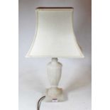 A carved alabaster table lamp, of fluted urn shape, on a square plinth, with shade, h.53cm