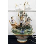 A large Lladro(?) porcelain model of a lady in a horse-drawn carriage, on a naturalistic base on a