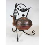 An Arts & Crafts copper kettle, of squat circular form, with raised sinuous floral decoration, on