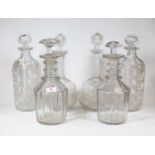 A near-pair of Regency cut glass triple ring neck decanters with mushroom stoppers (one stopper