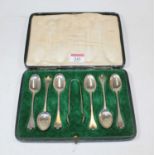 A set of six early 20th century silver teaspoons, in fitted case with associated silver tongs
