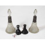 A pair of cut glass trumpet shaped scent bottles and stoppers, each with silver collar, together