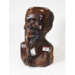 A large carved hardwood head and shoulders portrait bust of a man smoking a pipe, h.27cm