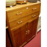 A 1930s oak compactum cabinet, having twin long upper drawers over conforming panelled lower