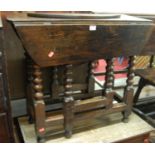 An antique provincial joined oak bobbin turned gateleg drop leaf occasional table (with damage to