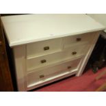 A contemporary pine and later white painted low chest of two short over two long drawers, width