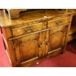 A contemporary joined oak low double door side cupboard, having twin frieze drawers and exposed