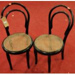 A pair of early 20th century ebonised bentwood and cane seat hoop back child's chairs