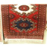 A Persian woollen red ground Bokhara rug, 180 x 122cmCondition report: Overall good and original