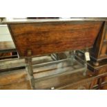 An antique joined oak dough bin, having a fall front panel raised on ring turned supports, united by