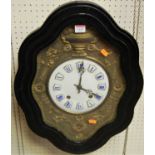 A late 19th century French ebonised vineyard clock, of typical shaped outline, with white