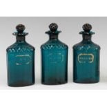 A set of three early 19th century green glass spirit decanters and stoppers, each annotated in