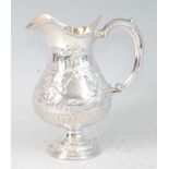 A late Victorian silver pedestal cream jug, of helmet form, having gilt-washed interior, the whole
