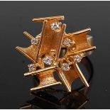 A yellow metal diamond abstract dress ring, comprising a textured angled bar design with seven 2mm