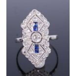 An Art Deco white metal lozenge shaped sapphire and diamond cluster ring, featuring a centre Old