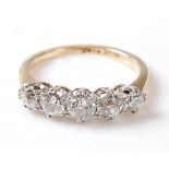 A yellow and white metal diamond five-stone half hoop eternity ring, featuring five graduated Old