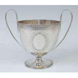 A George III silver twin handled cup, having bright cut engraved decoration (near-matching to