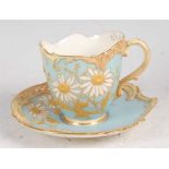 A Royal Worcester porcelain Empress teacup and saucer, shot enamel decorated with flowers and