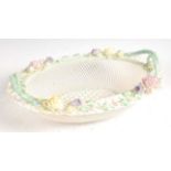 A first period Belleek porcelain basket, the flat rim encrusted with flower-heads and foliage over a