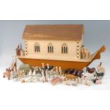 An early 20th century painted wooden Noah's Ark with numerous animals and figures, the animals