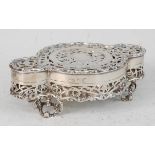 A George V silver trinket box, of circular form with proud ends, the pierced hinged cover over a