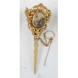 A 19th century French gilt metal posy holder, having turned mother of pearl handle, the posy