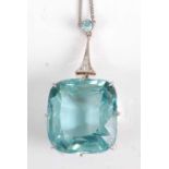 An Art Deco yellow and white metal, aquamarine and diamond pendant, the principal cushion cut