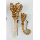 A late 19th century continental gilt metal and enamel decorated posy holder, having turned mother of