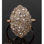 A yellow and white metal marquise shaped panel cluster ring, comprising 33 Old European cut diamonds